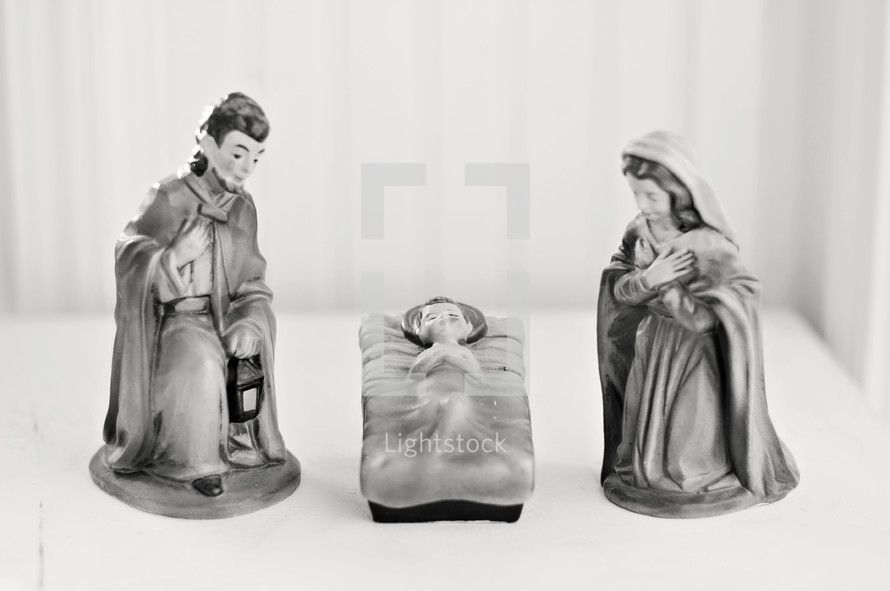 Nativity figurines -- Joseph, Mary, and Baby Jesus in a manger.
