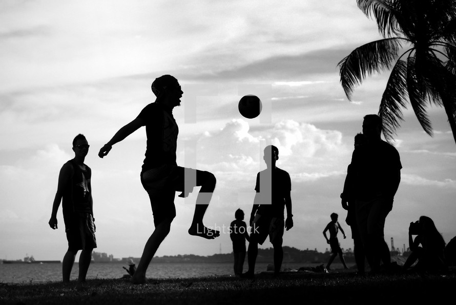 playing soccer on a beach