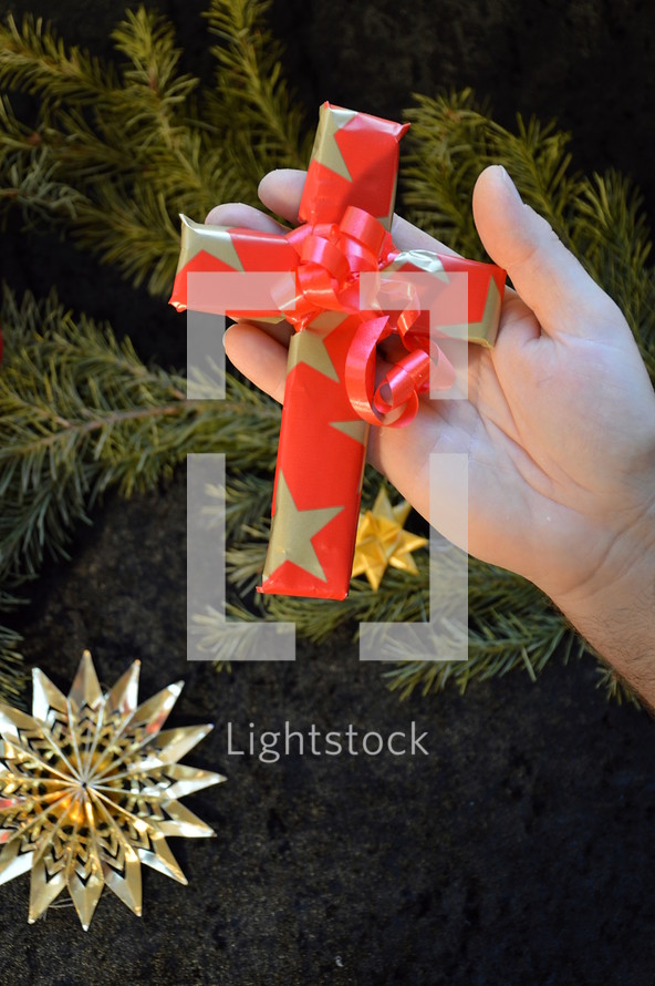 cross wrapped in paper as a present at Christmas day. 
presents, present, cross, Christmas, birth, death, born, die, dying, give, given, gave, son, advent, save, savior, saving, redeem, redeeming, redeemer, Christmas day, tree, fir, branch, twig, gift, star, stars, red, golden, wrap, wrapped, wrapping, wrap, packaging, packing, packed, pack, Xmas, fancy paper, gift wrap, wrapping paper, hand, offer, provide, offering, providing, ornament, decoration, decorate, decorating