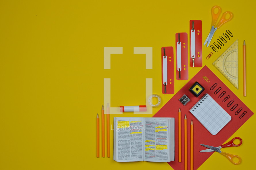 office supplies in red and yellow and Bible 