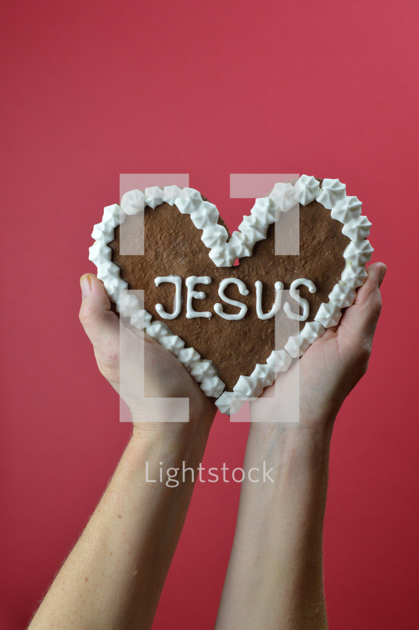 heart shaped cookie with the word Jesus 