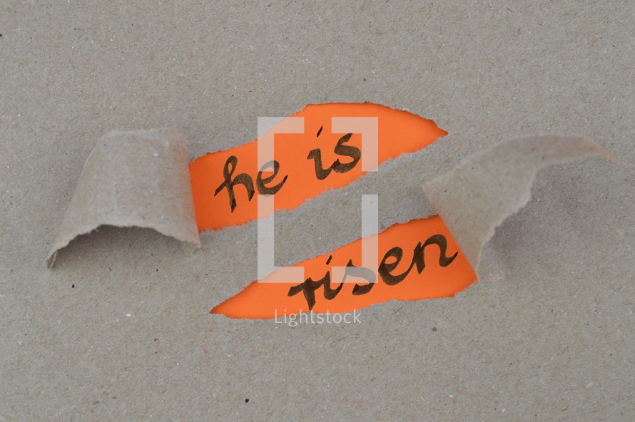 ripped open paper with the words HE IS RISEN