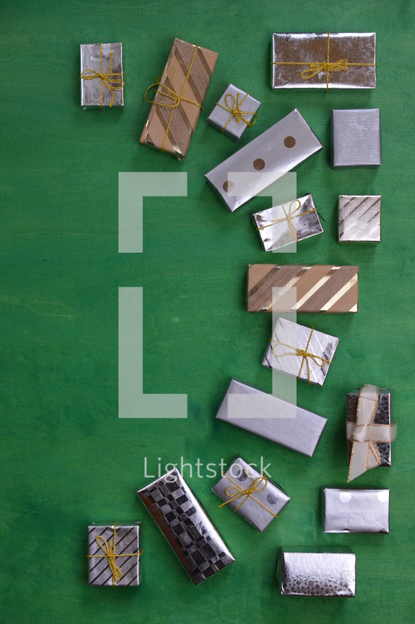 many little presents building a frame on a green wooden background