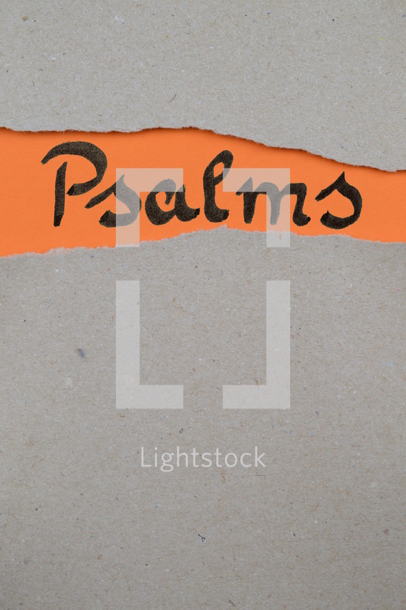 torn open kraft paper over orange paper with the name of the book of Psalms