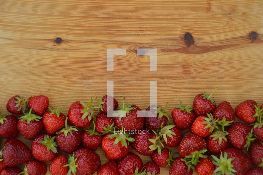 a border of fresh red strawberries 