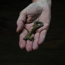 rusty key in a hand 