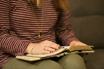 a teen girl with Bibles and journals in their laps at a Bible study 