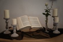 open Bible with candlesticks 