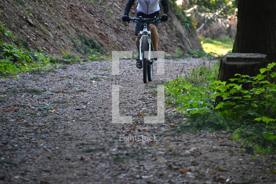 man riding a bicycle. 
bikes, bike, biking, bicycle, bicycles, cycle, cycles, wheel, wheels, rolling, roll, ride, riding, rider, pedal, sport, sports, move, moving, fast, speed, speeding, spin, spinning, cycling, tour, exercise, exercising, work out, workout, training, practice, sporty, sporting, athletic, sportingly, athletically, fit, thoroughly fit, well-conditioned, well-toned, buff, stamina, stamina training, condition, road, off road, quick, quickly, rapid, rapidly, swift, speedy, off road, street, way, path, route, lane, trail, outdoor, outside, abroad, outdoors, in the open, alone, single, solitary, individual, solo, forest, woods 