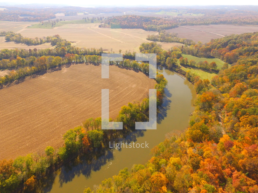 aerial view over a rural river in fall 