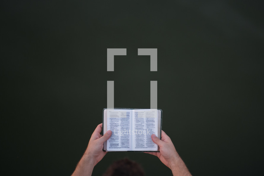 a man reading a pocket Bible 