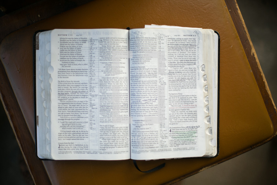 an open Bible lying in a chair 