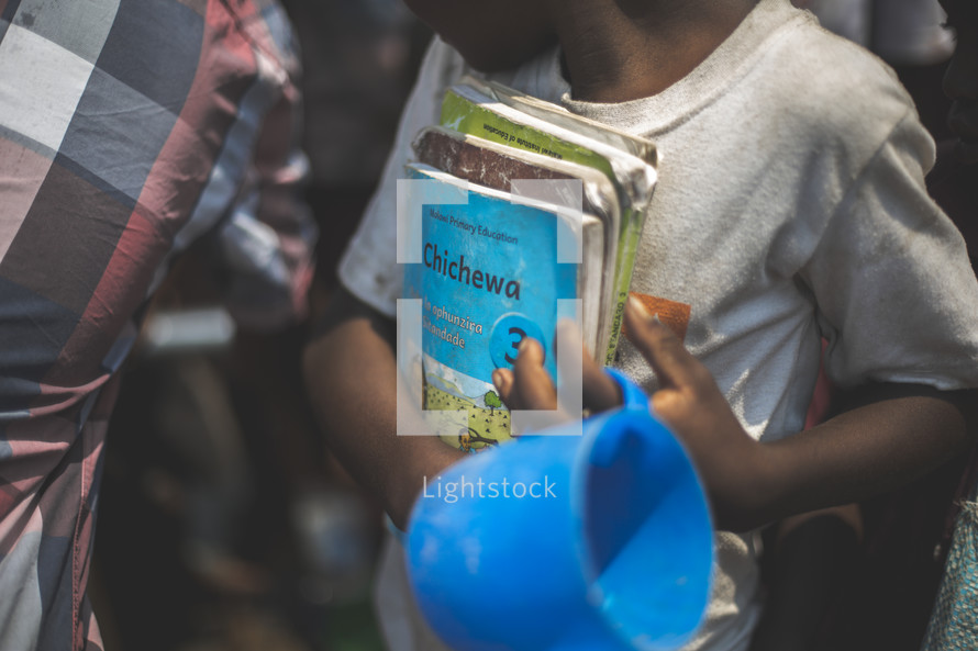 children holding children's Bibles 