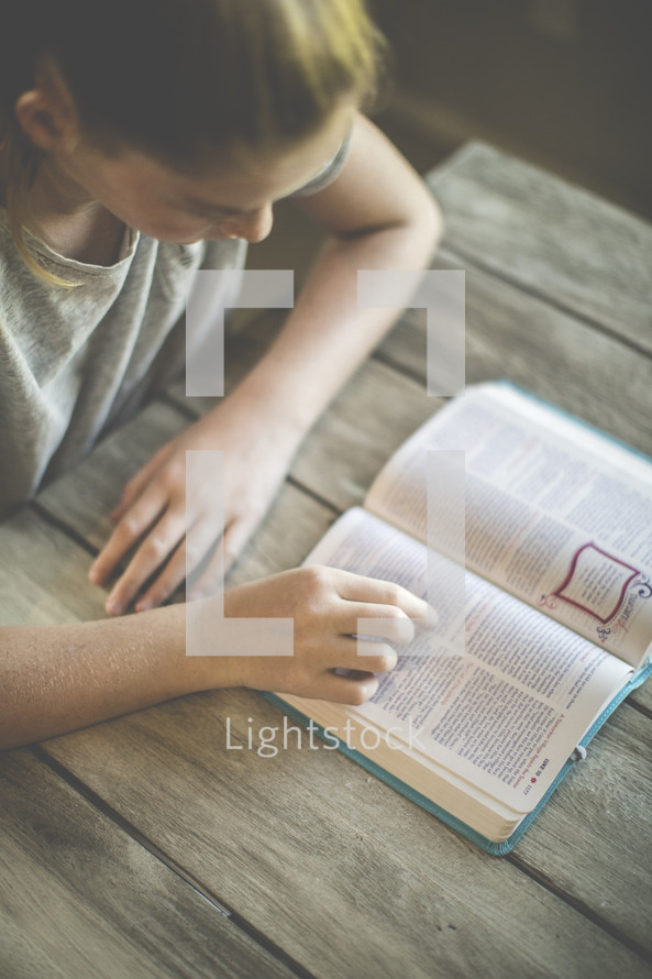 a girl reading a Bible 