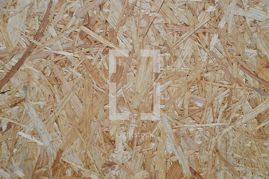 oriented strand board. 
oriented strand board, OSB, wood, background, texture, panel, plank, rough, raw, bleak, grain, vein, wall, abstract, notional, conceptional, boarding, board, wooden, timber, lumber, framing, structural, structural work, woodfiber, woodfibers, woodfibre, wood fiber, fiber, fibrous, brown
