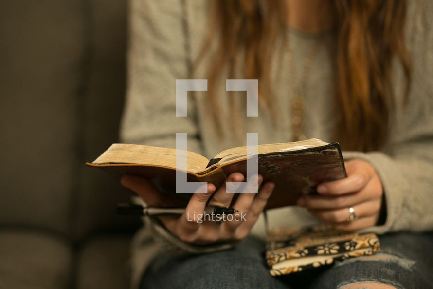 teen girl with Bibles and journals in their laps at a Bible study 