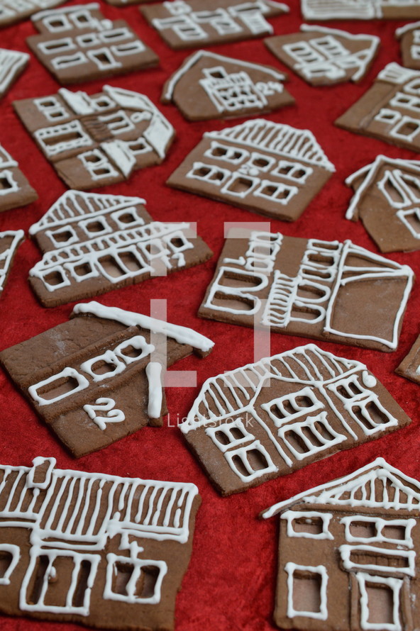 crisscross pattern out of 24 self baked different gingerbread houses on red as edible advent calendar