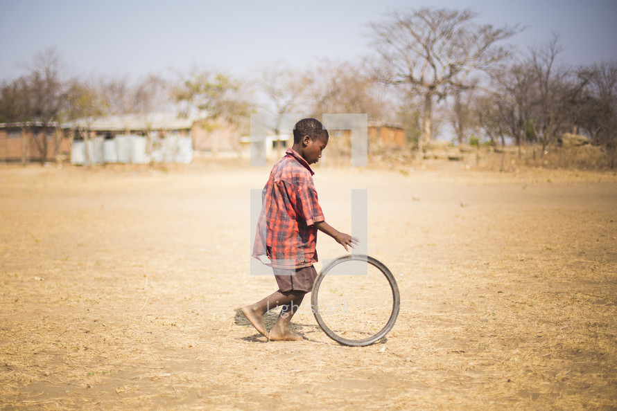 a child rolling a wheel 
