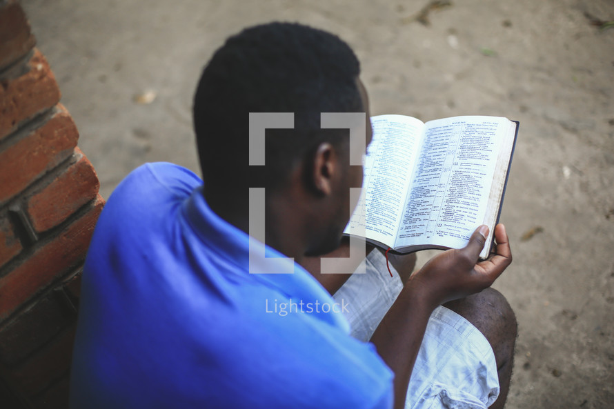 men reading Bibles on a mission trip 