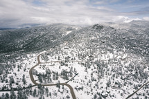 Aerial view of winding snowy road in mountains