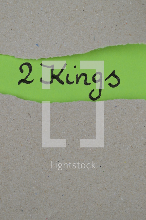 torn open kraft paper over green paper with the name of the book 2 Kings