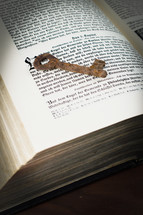 rusty key on the pages of an old book - the key of David on the book of revelations