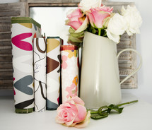 vase of roses and books with book covers 