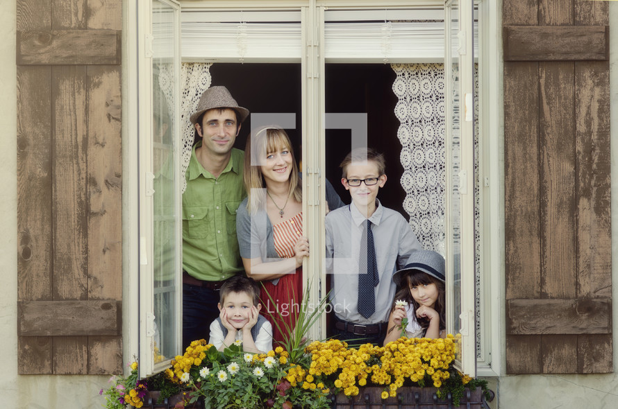 family looking out an open window