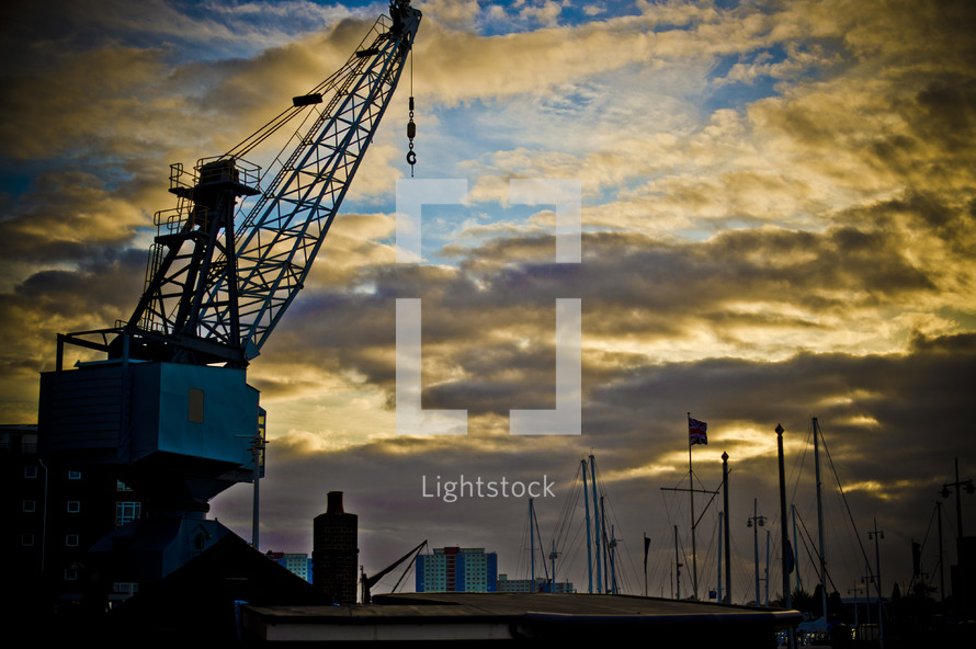 Crane in an industrial area at dusk.