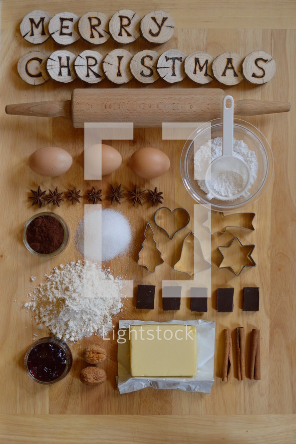 Baking ingredients with wooden pieces and the words MERRY CHRISTMAS burned into them