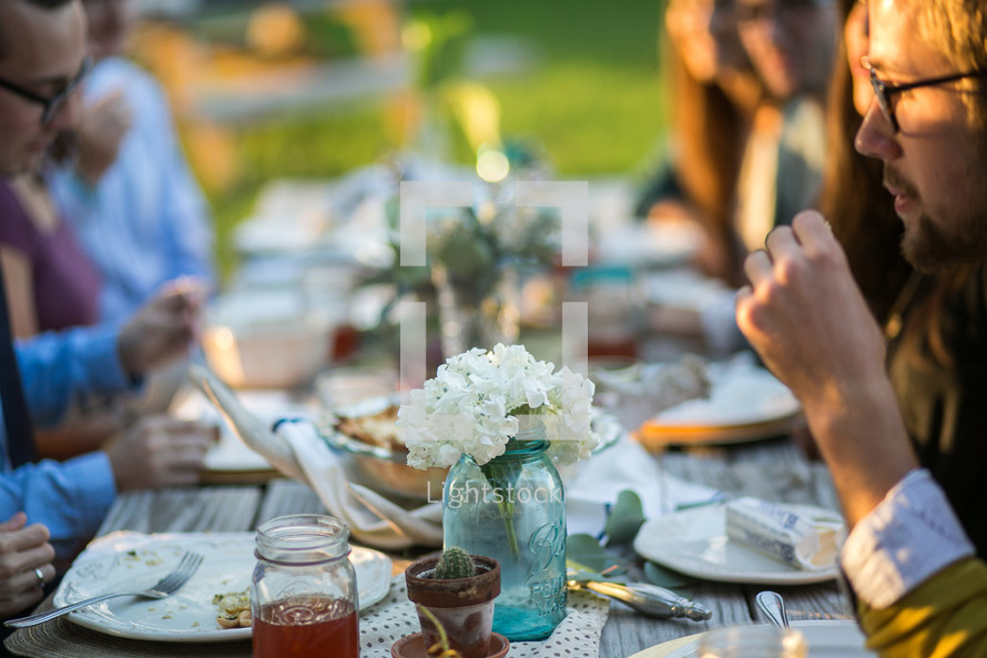 A family enjoying dinner together outdoors 