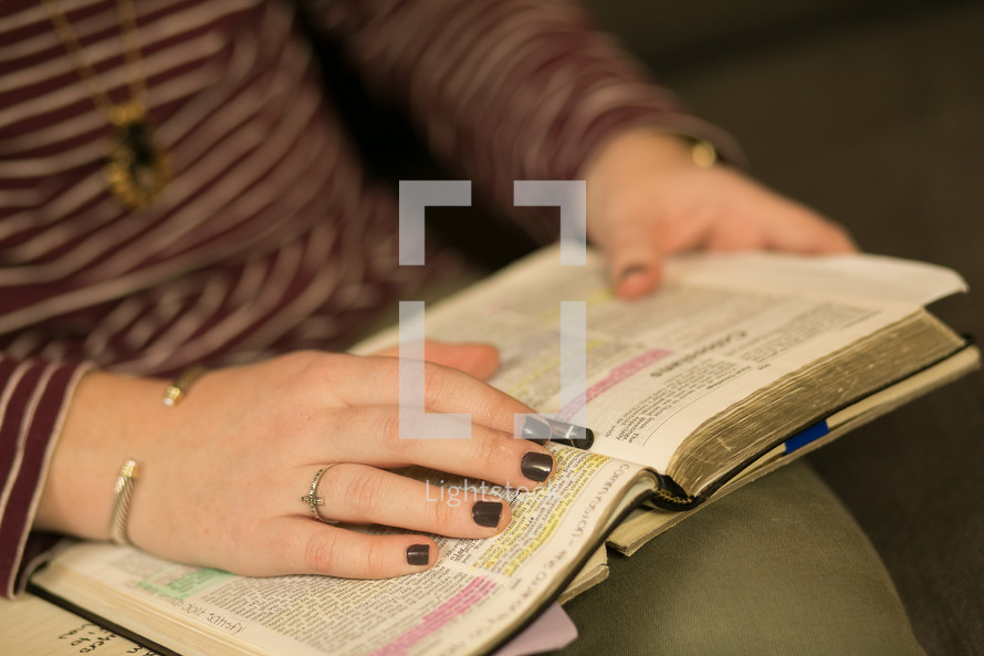 a teen girl with Bibles and journals in their laps at a Bible study 