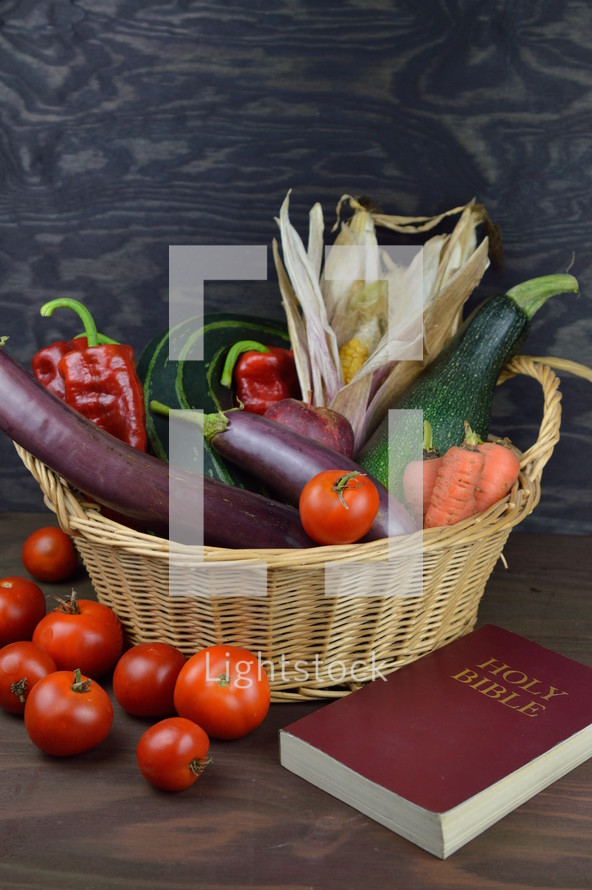 harvest basket and Holy Bible on a wood background 