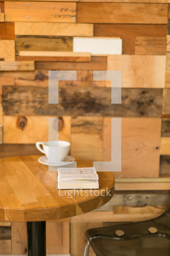 coffee cup and Bible on a table in a coffee shop 