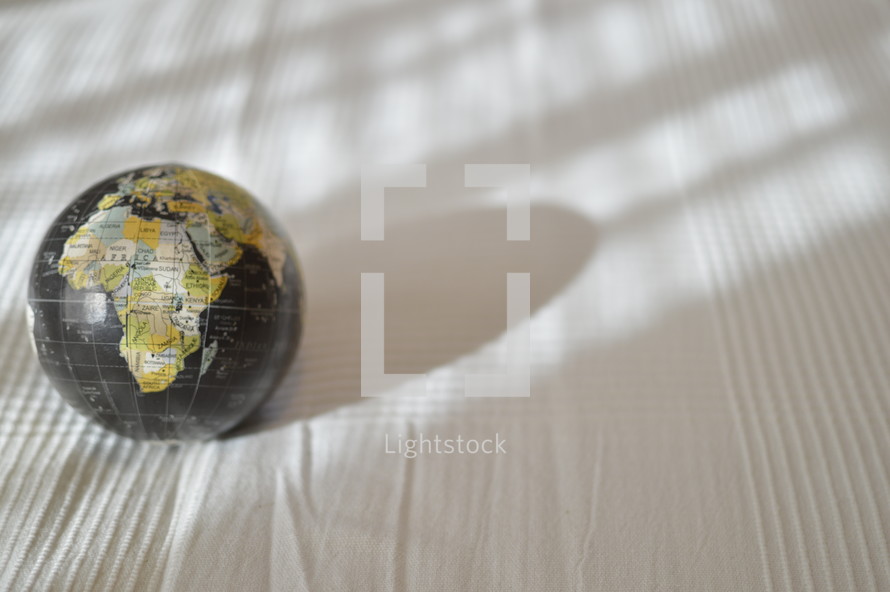globe on a white table cloth 