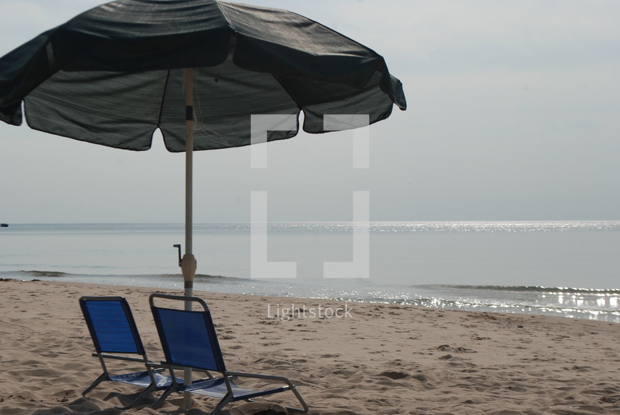 chairs and umbrella on a beach 