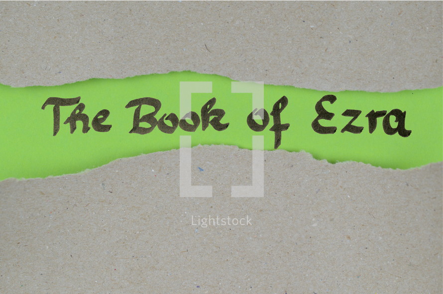 The Book of Ezra - torn open kraft paper over green paper with the name of the book Ezra