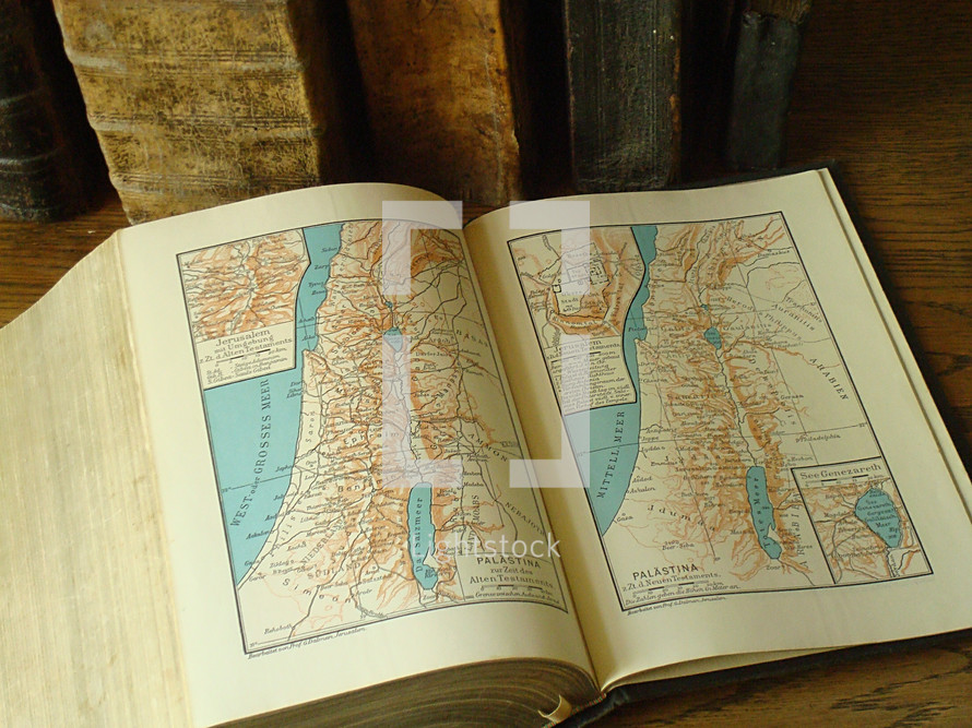 Old books with maps of Israel.