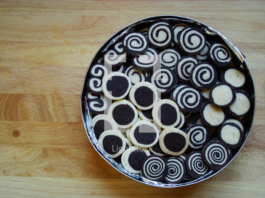 black and white christmas biscuits in a tin


