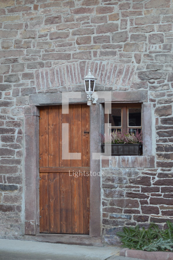 old brown wooden door on a stone building 