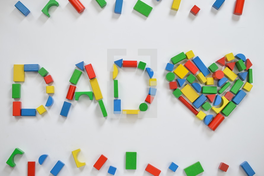 wooden blocks in the shape of a heart and the word dad
