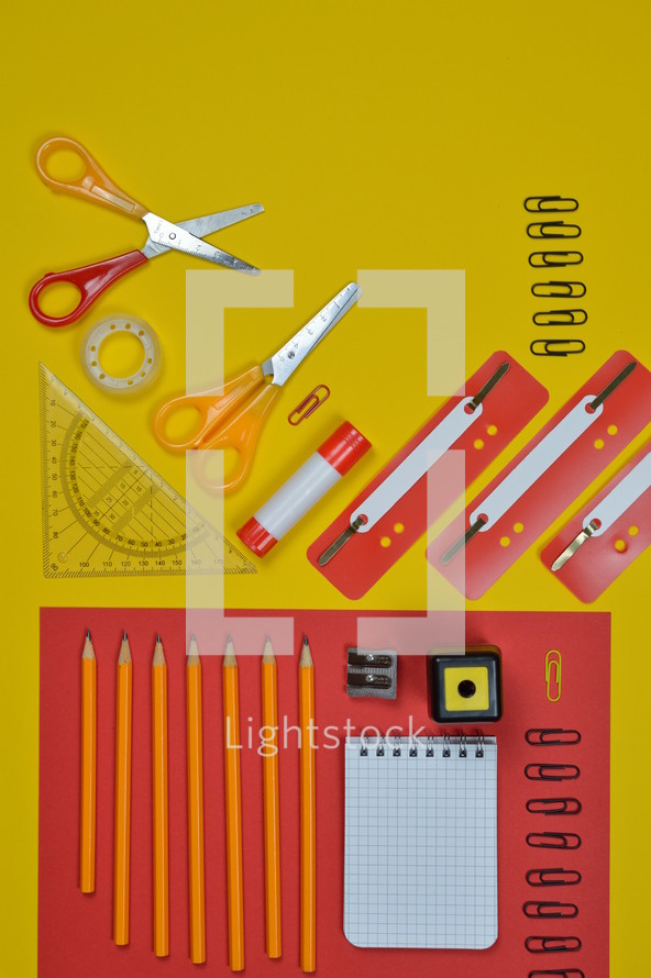 office supplies on red and yellow 