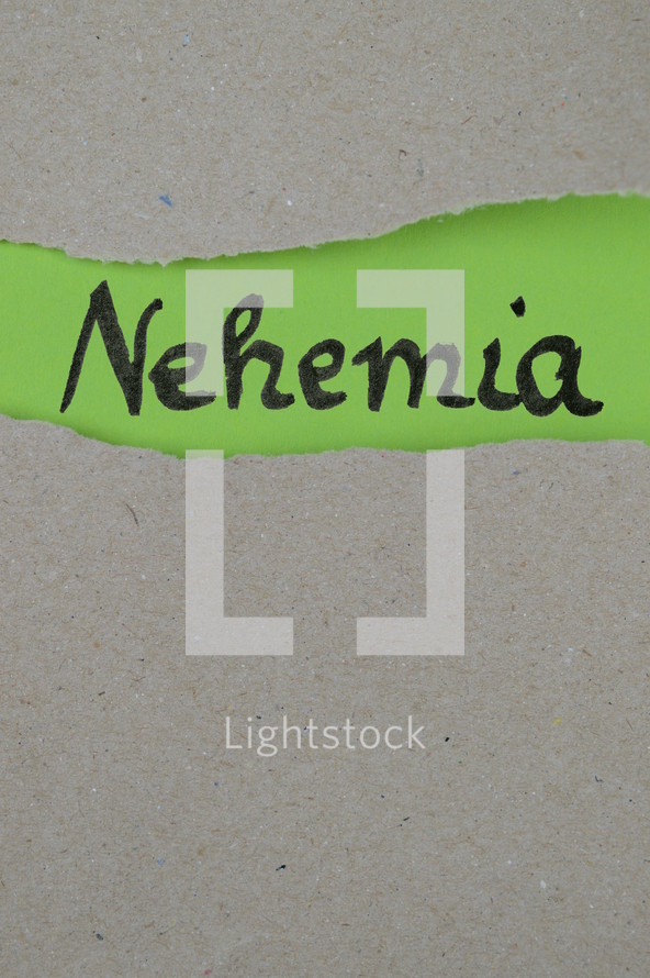 torn open kraft paper over green paper with the name of the book Nehemiah 