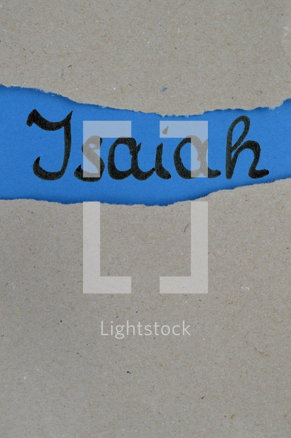 Isaiah - torn open kraft paper over blue paper with the name of the prophetic book  Isaiah