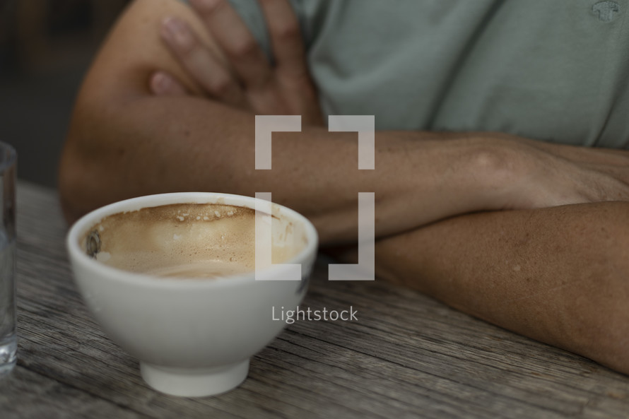 Man with arms cross and coffee