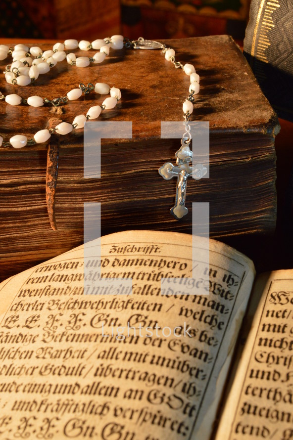 a rosary on an old Bible 