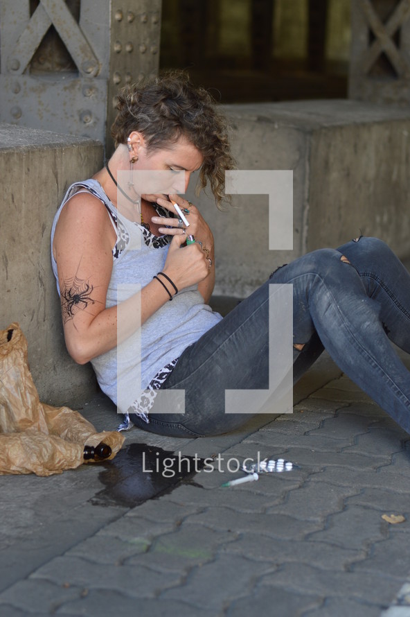 a homeless woman getting high with drugs 