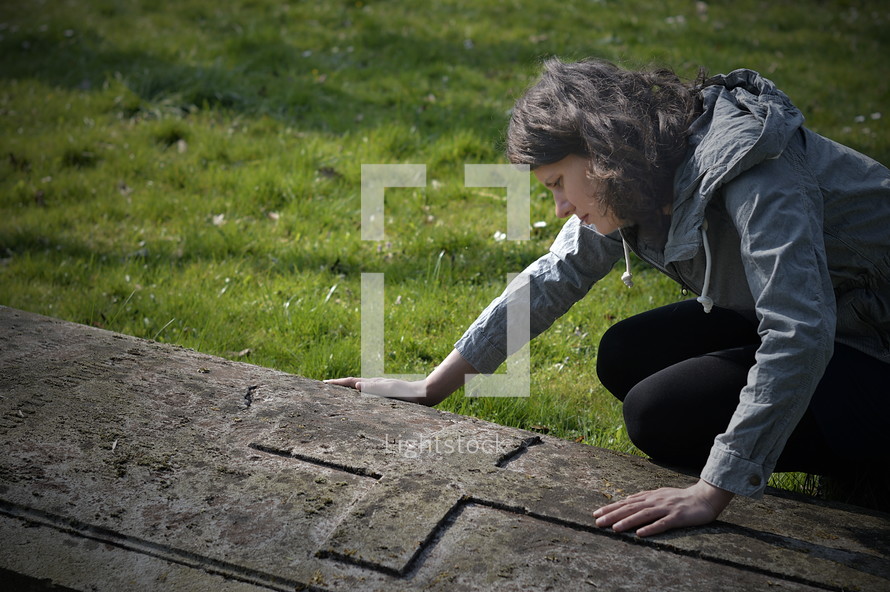 grieving woman at a grave site 