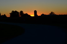 silo and orange sky at sunset 