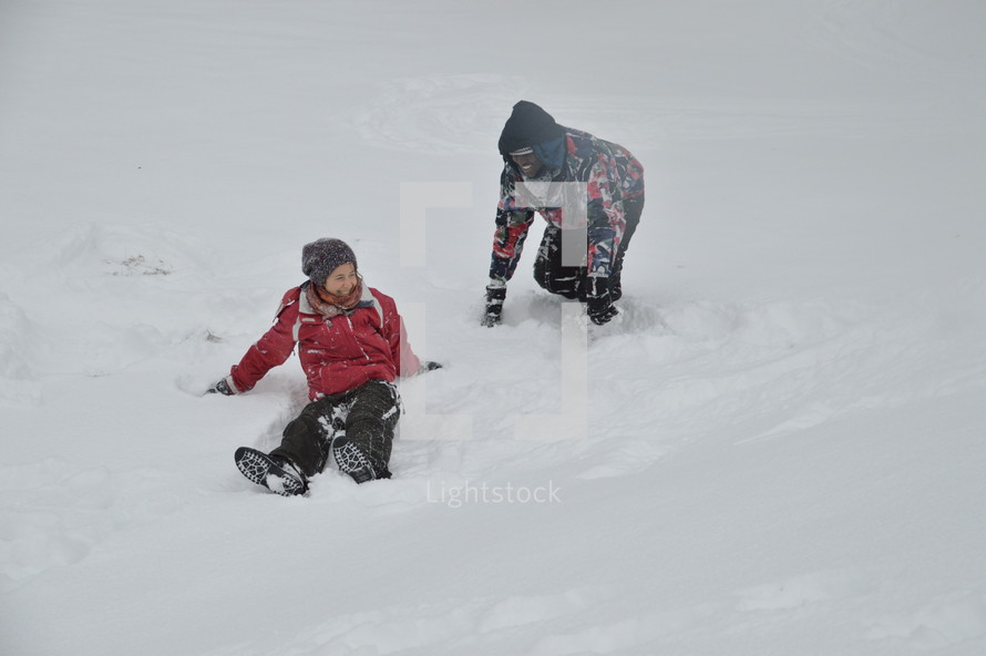adults playing in the snow 